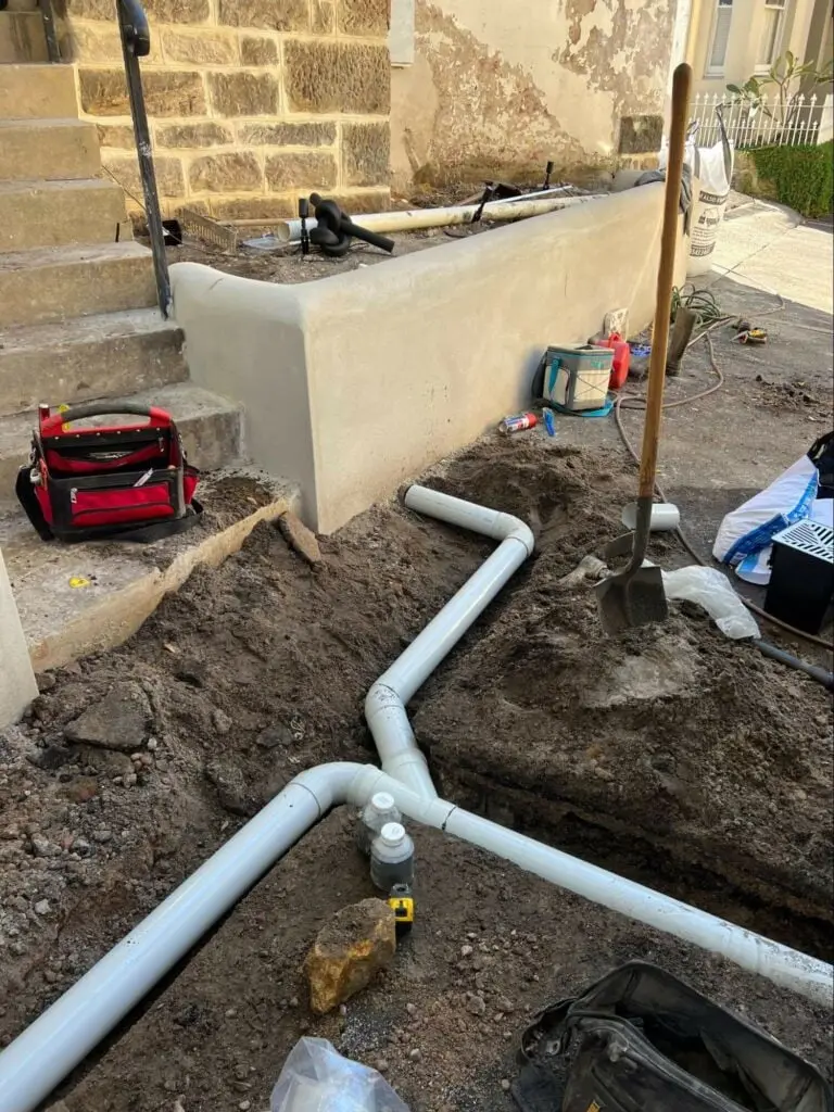 New stormwater pipes laid along a retaining wall